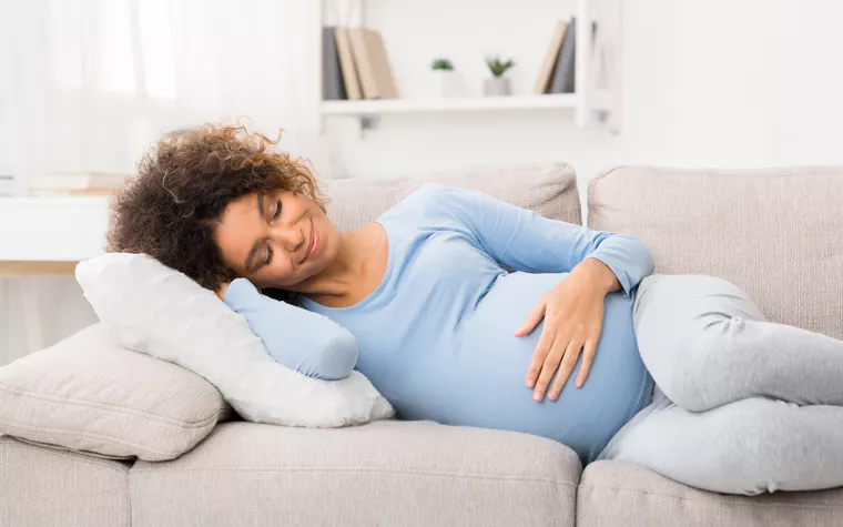 Pregnant woman on sofa