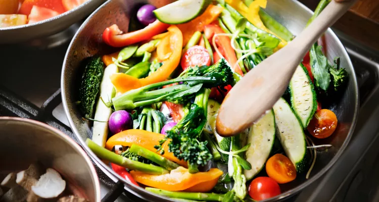 Healthy foods in pans on stove