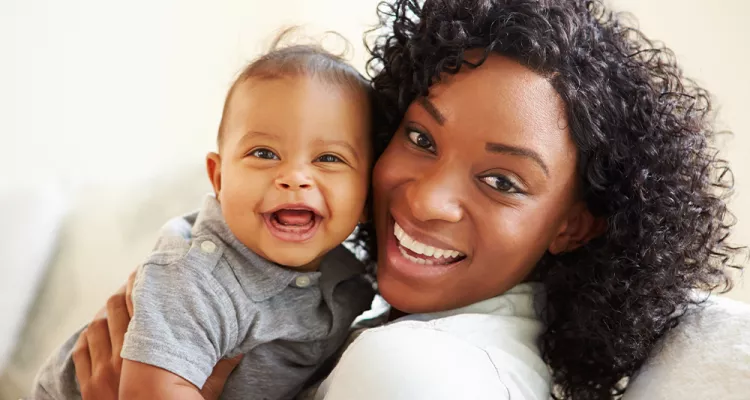 Smiling mom with happy baby